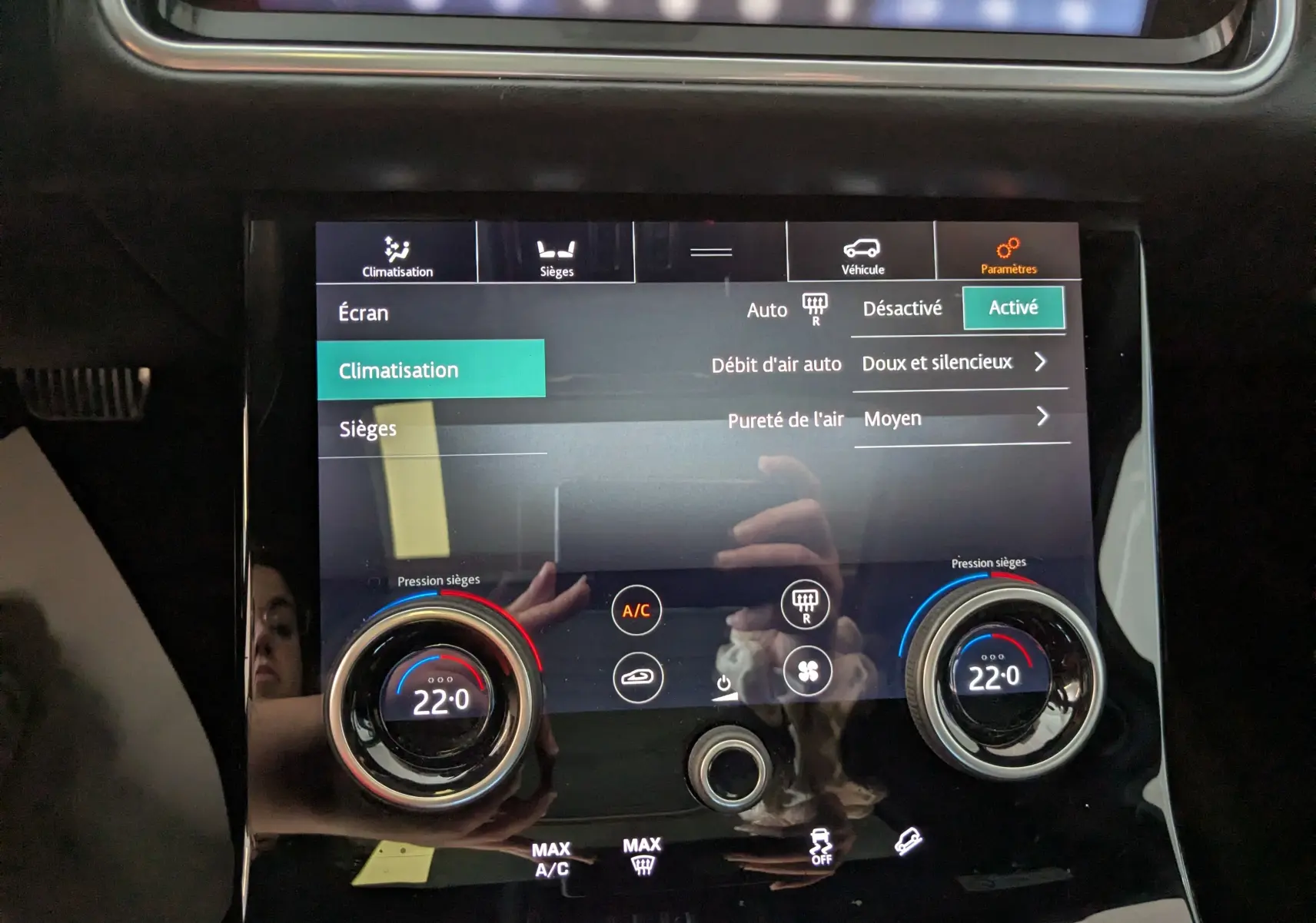 Écran tactile central du Range Rover Velar noir 2020 affichant les réglages de climatisation à 22 degrés.