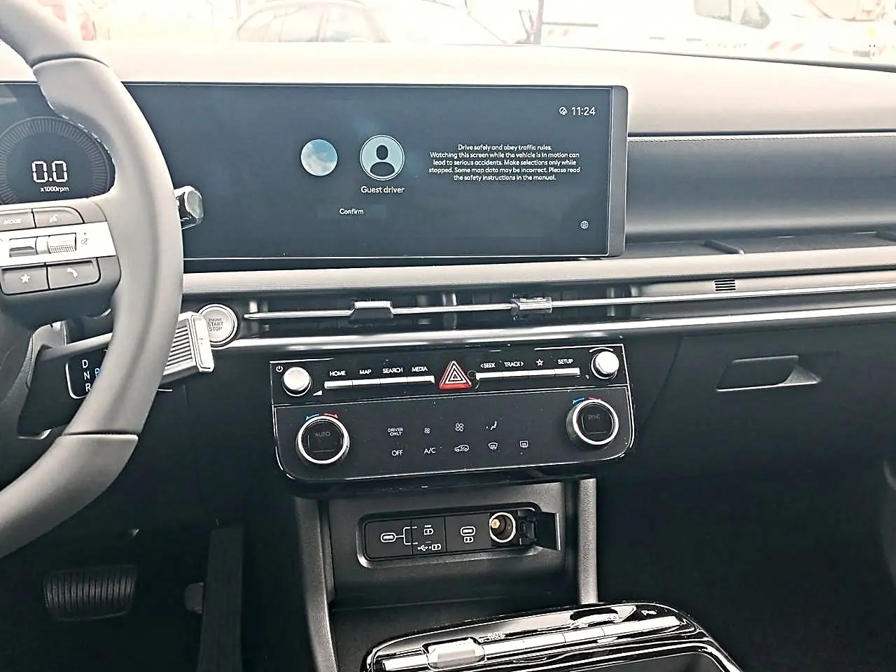 Vue intérieure du tableau de bord et console centrale du Hyundai Tucson 2026 gris, avec écran tactile large et commandes climatisation.