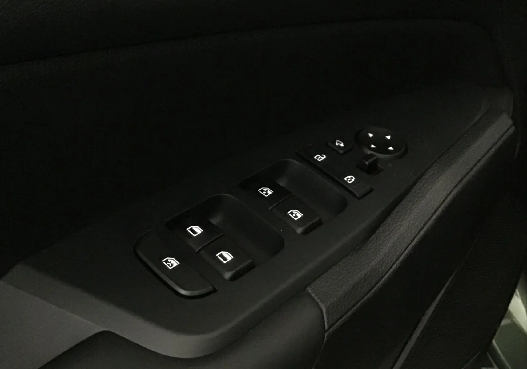 Gros plan sur les commandes de lève-vitres et rétroviseurs côté gauche intérieur du Kia Sportage blanc 2025.