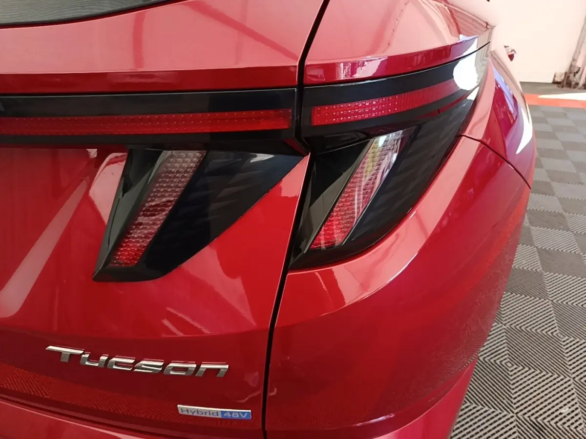 Gros plan sur l'arrière droit rouge du Hyundai Tucson avec feux arrière LED et logo Tucson visible.