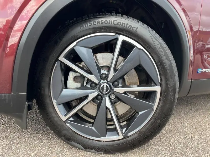 Gros plan sur la jante alliage 19 pouces noire et argent du Nissan Qashqai e-POWER Rouge Passion côté avant droit.