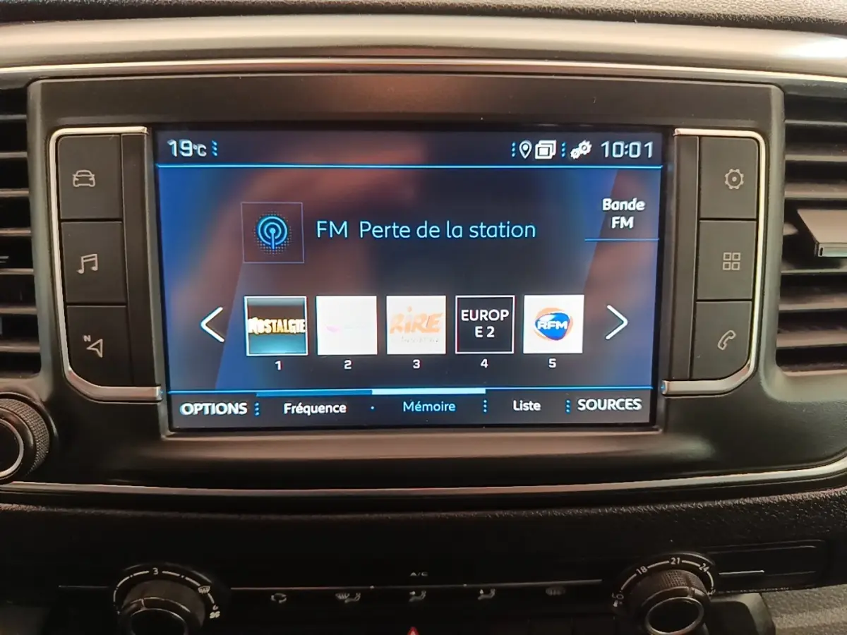 Écran tactile central du tableau de bord du Peugeot Expert Fourgon blanc, affichant les options radio FM.