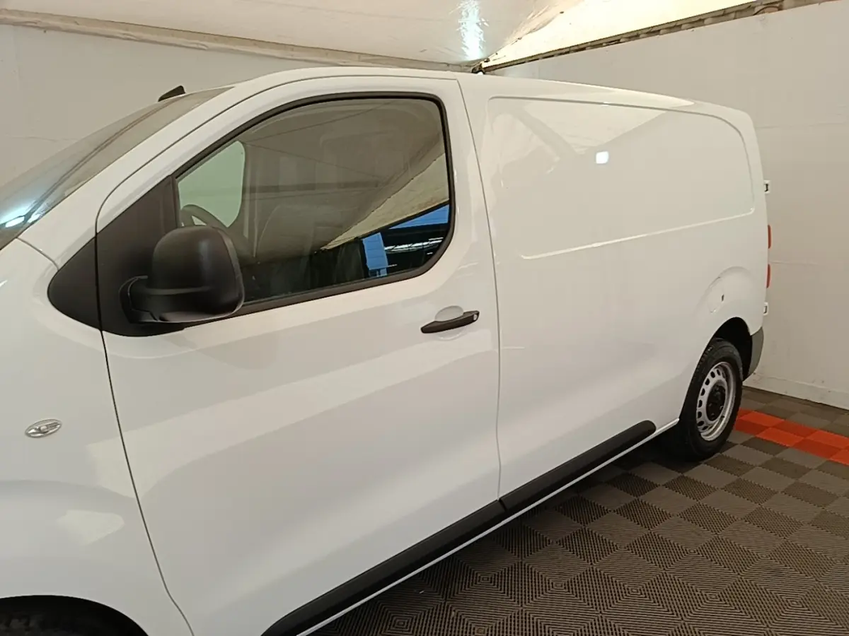 Peugeot Expert Fourgon blanc vu de profil côté gauche, avec porte latérale coulissante et jantes acier noires.