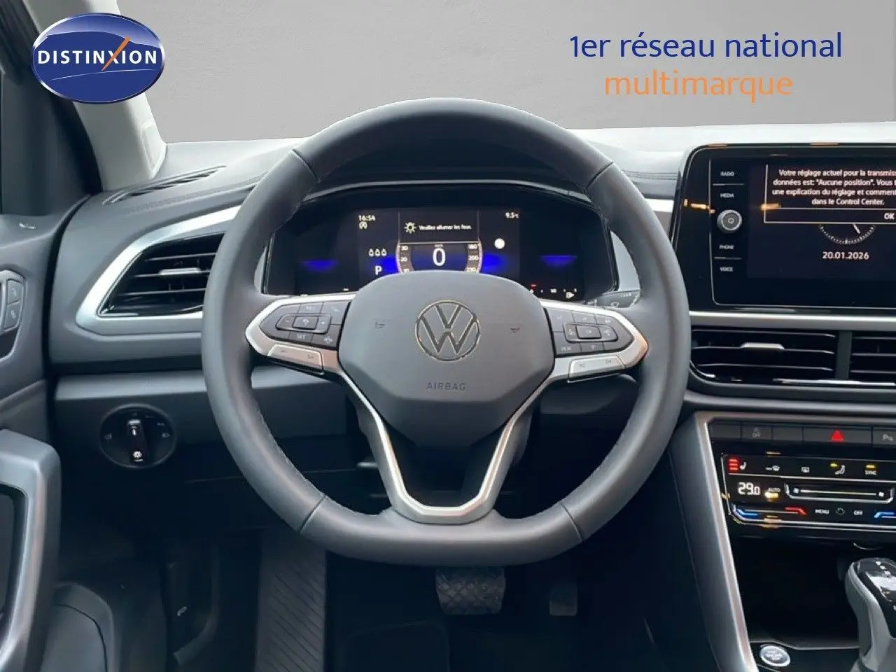 Vue centrée sur le volant et le tableau de bord numérique d'un Volkswagen T-Roc noir Grenadilla, intérieur moderne et connecté.