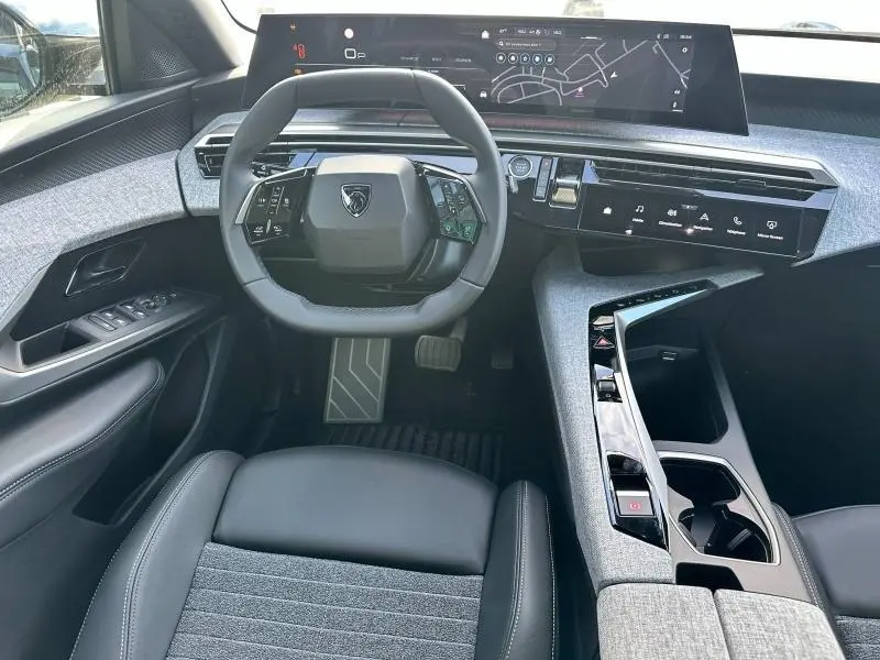 Vue intérieure avant du Peugeot 3008 2025 avec volant cuir multifonction et tableau de bord numérique large.