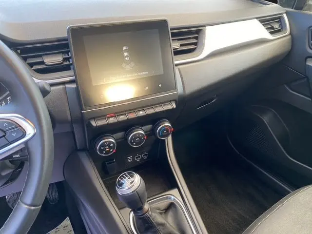 Intérieur avant droit du Renault Captur TCE 90 Équilibre 2023, tableau de bord gris noir avec écran tactile et boîte manuelle.