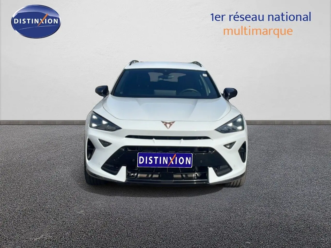 Vue frontale d'un CUPRA Formentor blanc neige métal, avec calandre marquée et phares LED anguleux.