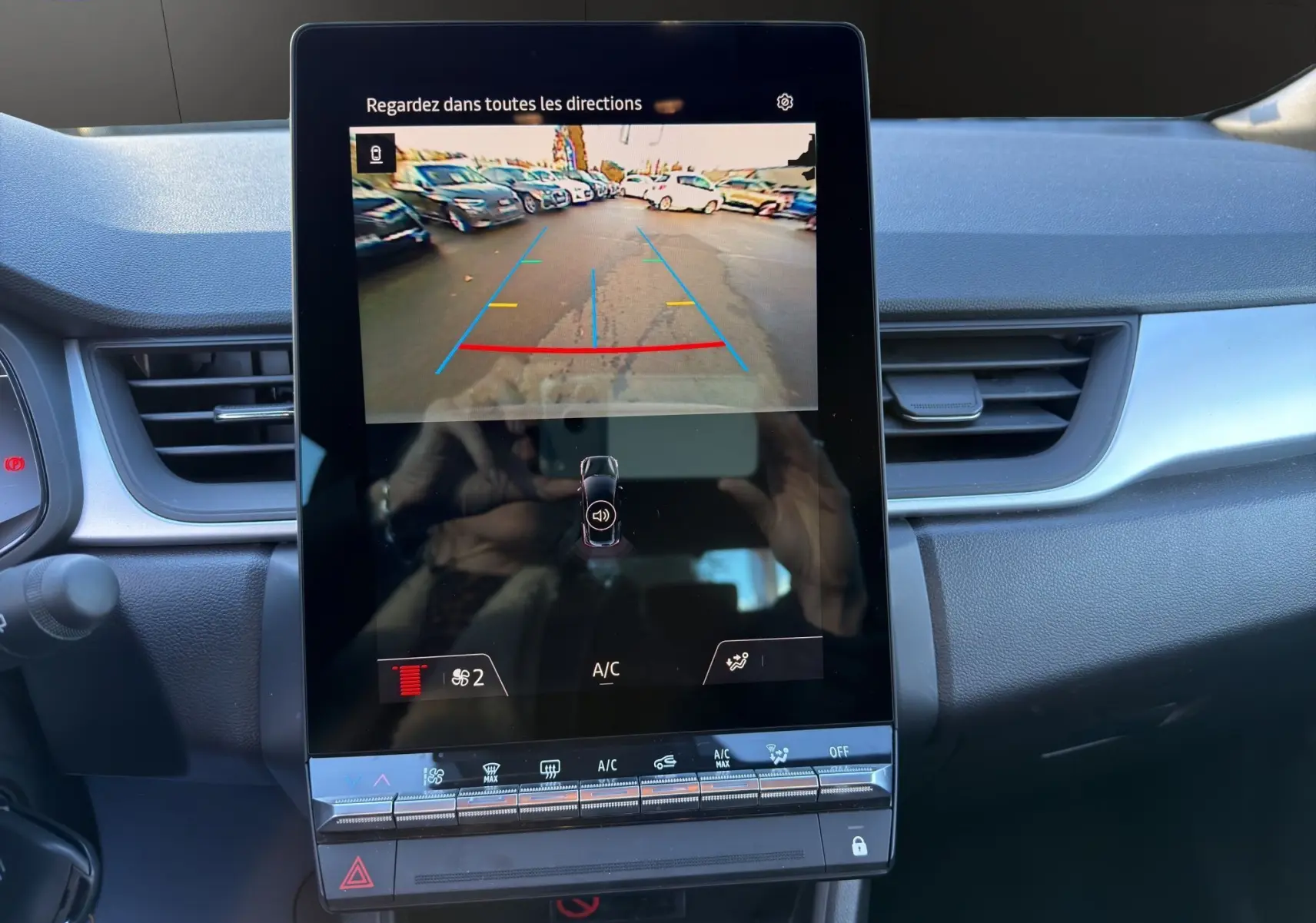 Vue intérieure centrée sur l'écran tactile de la caméra de recul du Renault Captur 2024, tableau de bord gris.