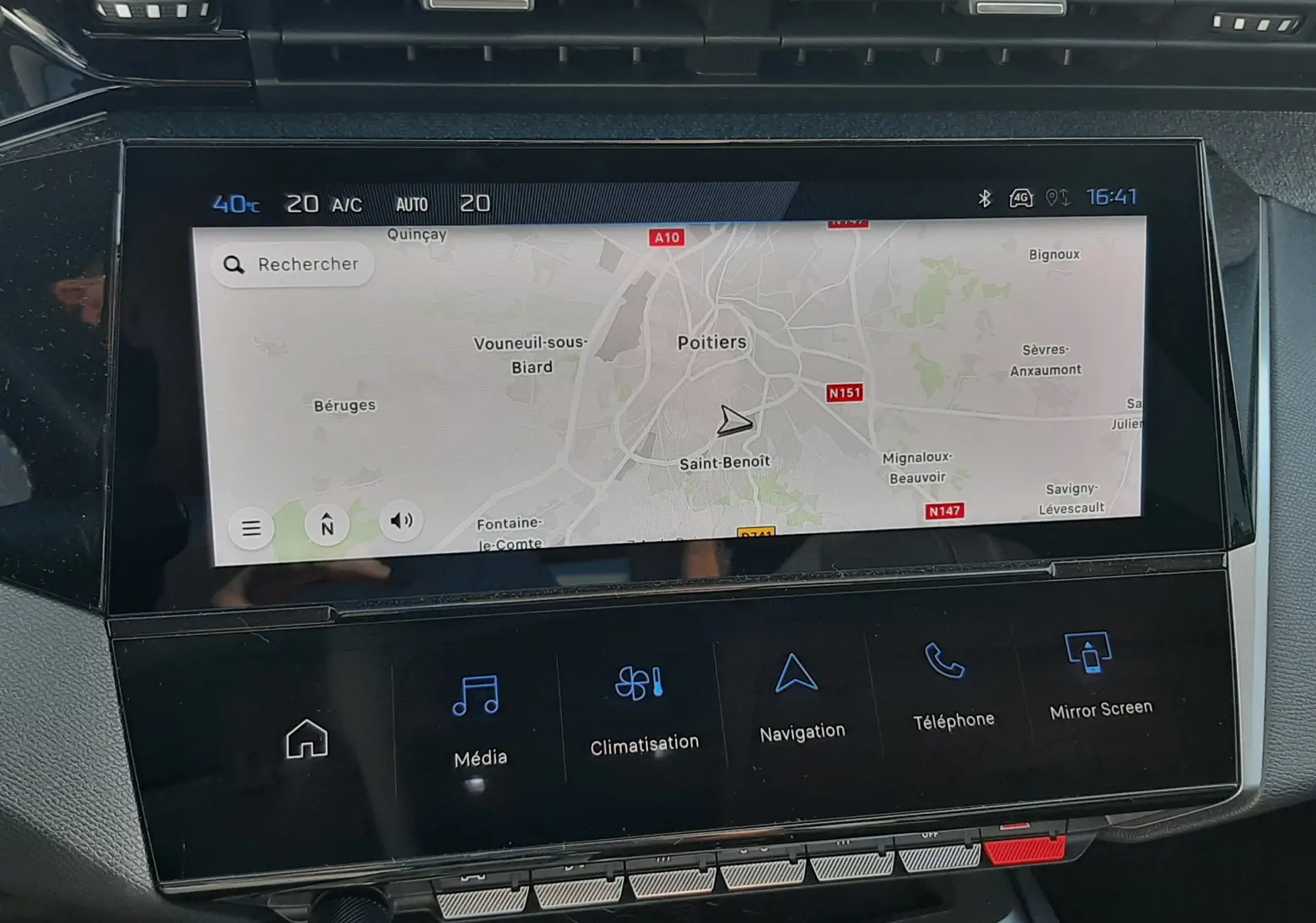 Vue rapprochée de l’écran tactile central du tableau de bord de la Peugeot 308 blanche, affichant la navigation GPS.