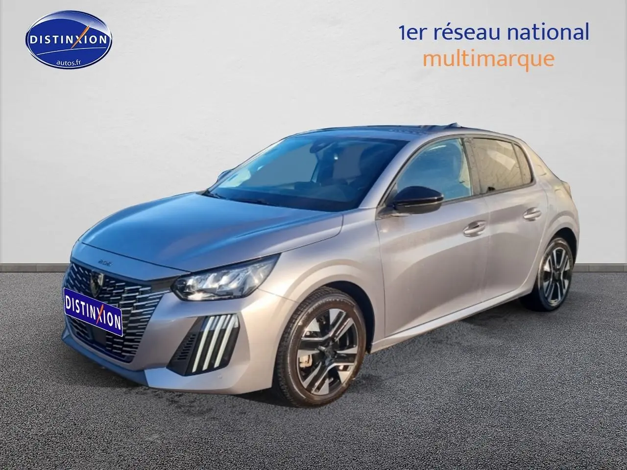 Peugeot 208 gris artense vue 3/4 avant droit, avec jantes alliage et phares LED distinctifs.