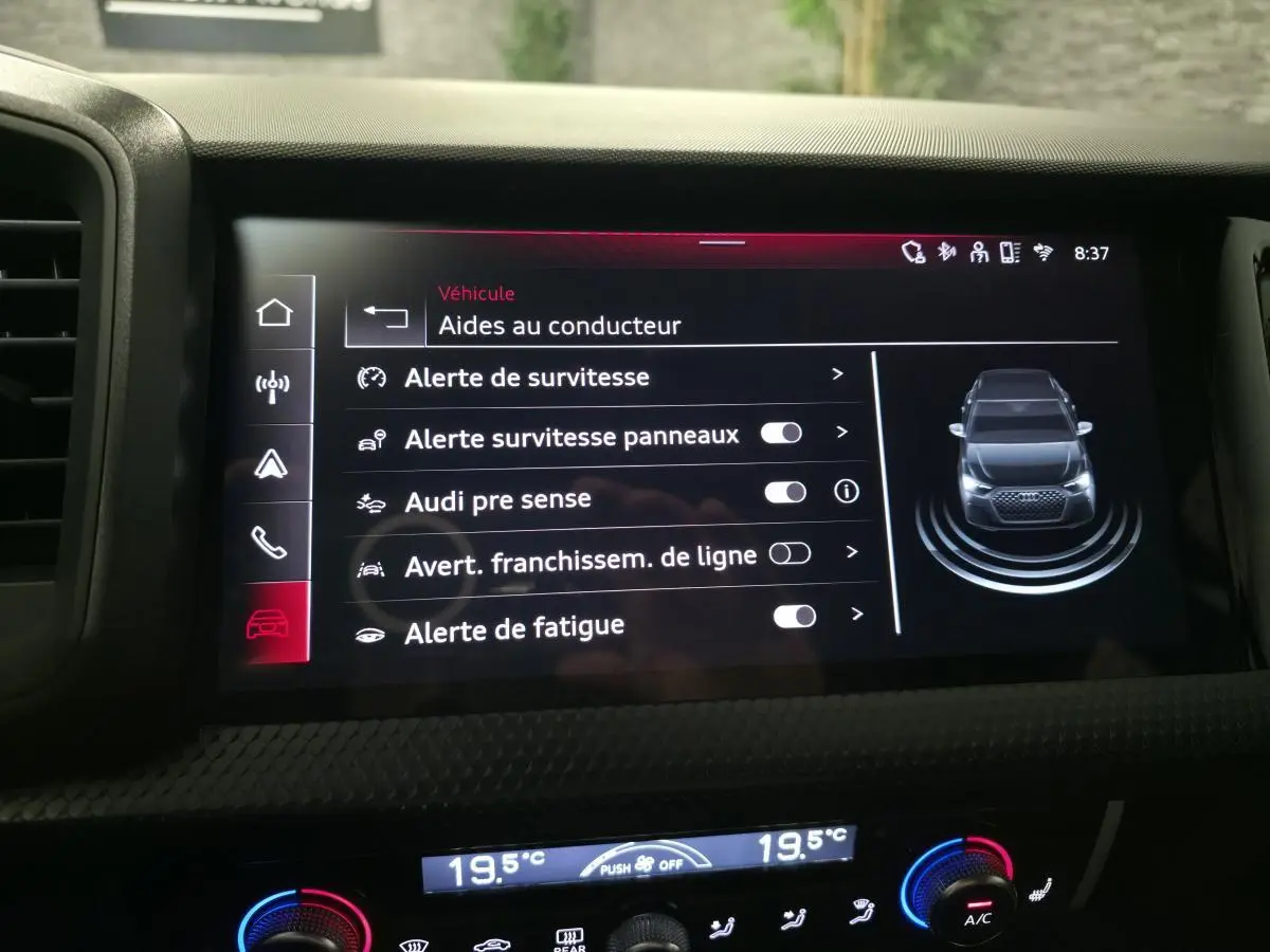 Écran central intérieur montrant les aides au conducteur sur Audi A1 Sportback gris Manhattan, tableau de bord noir.