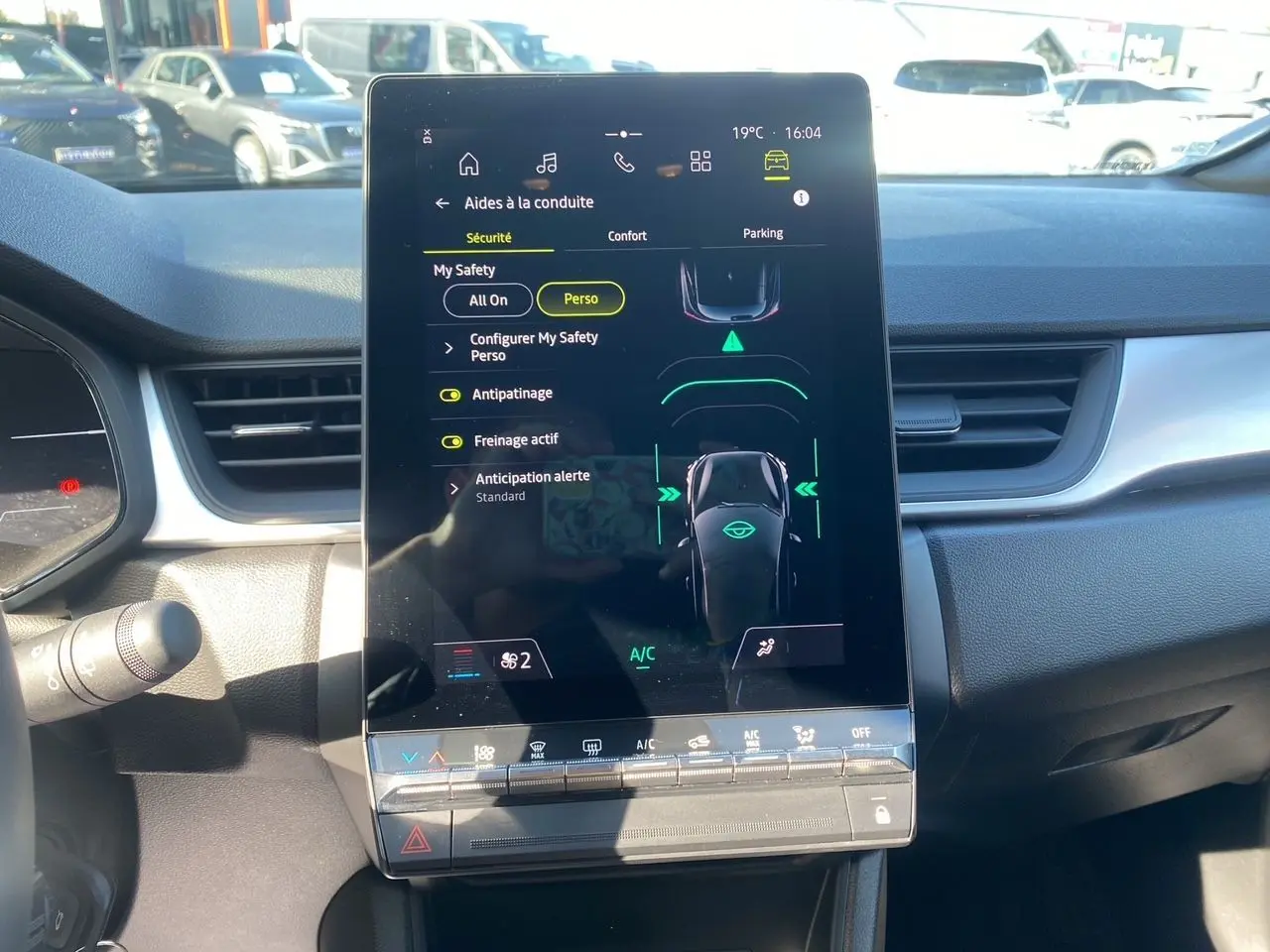 Écran tactile central du tableau de bord du Renault Captur TCE 90 Evolution 2024, avec interface d’aides à la conduite visible.