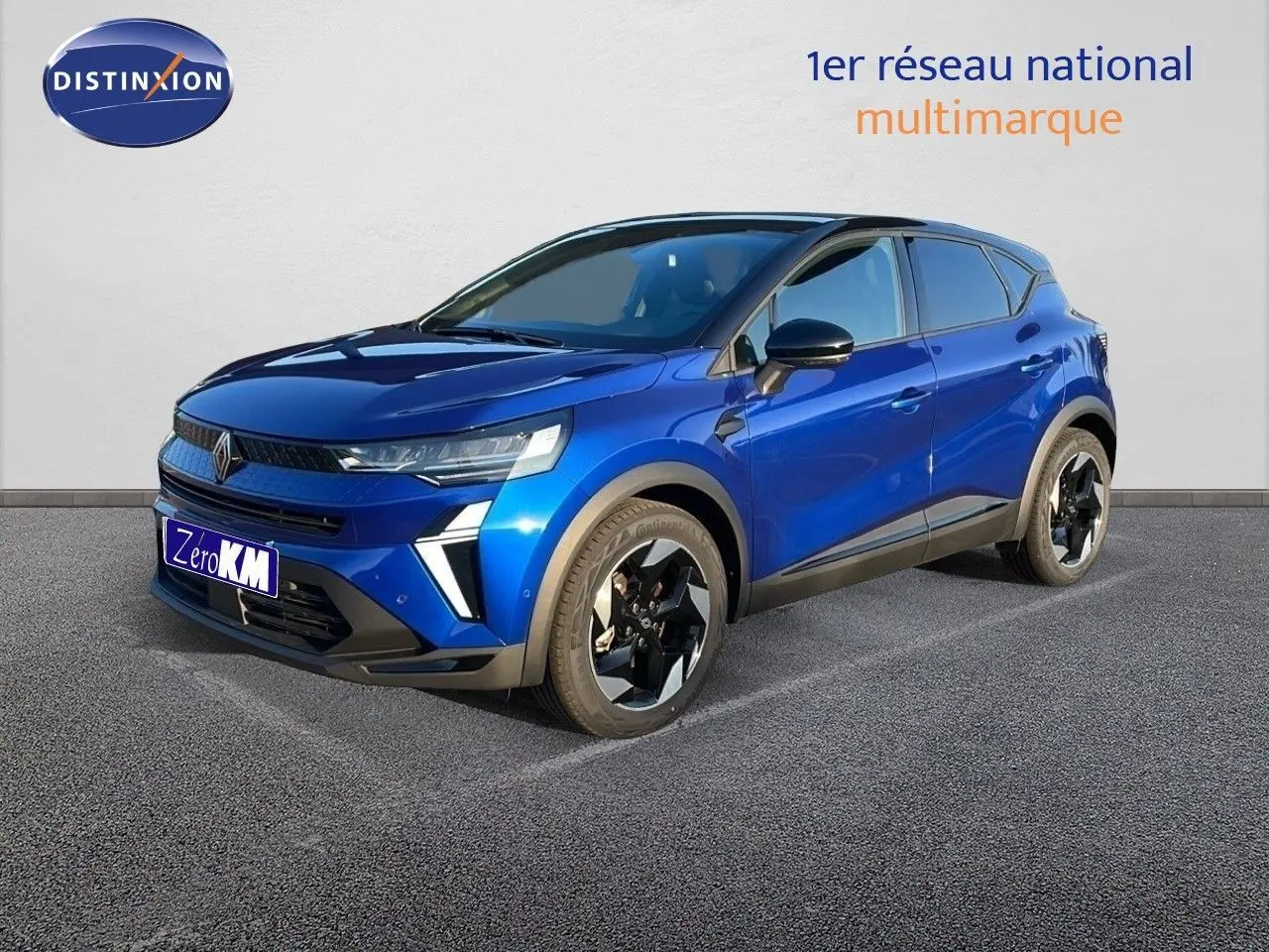 Renault Captur E-Tech hybride 2025 bleu iron métal avec toit noir, vue 3/4 avant côté droit sur sol gris.
