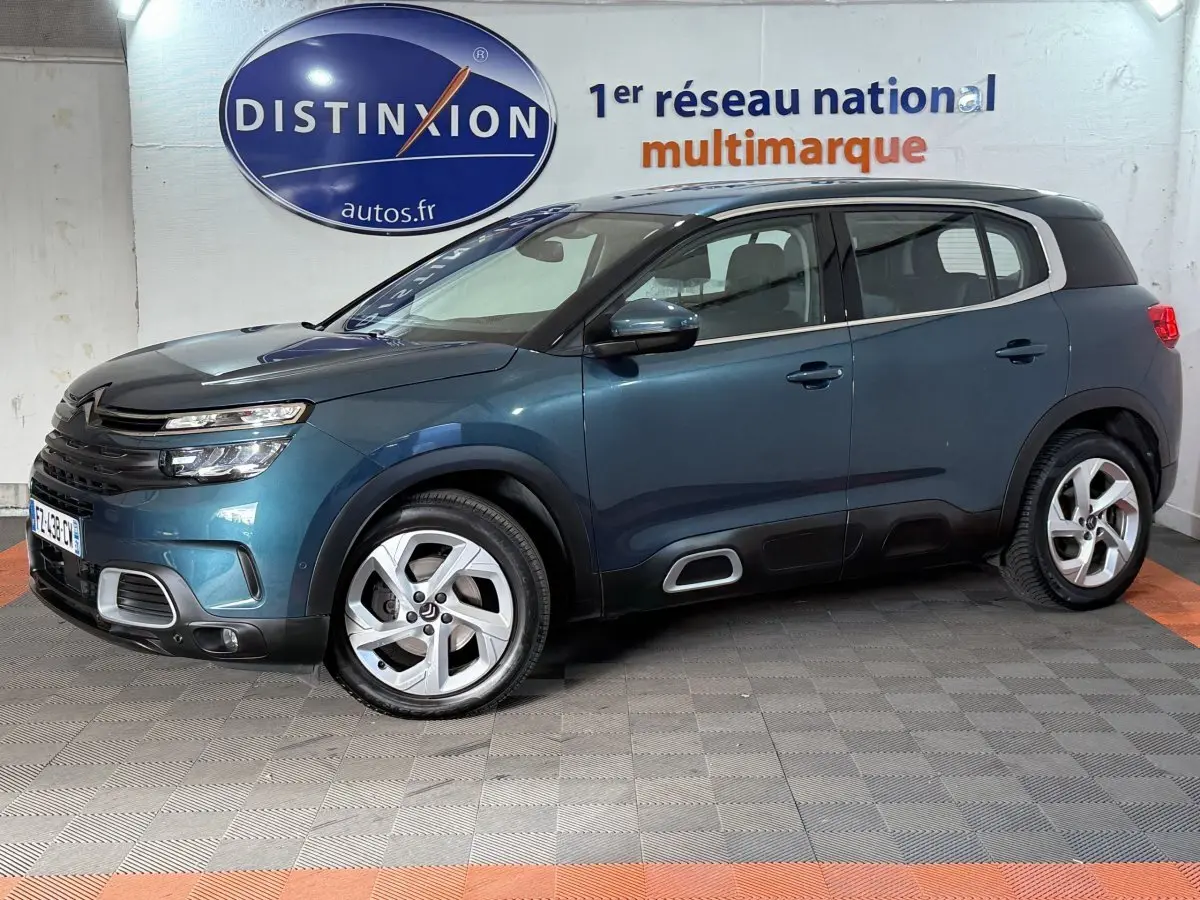 Citroën C5 Aircross bleu en profil droit, avec jantes alliage et détails noirs contrastants, en intérieur showroom.