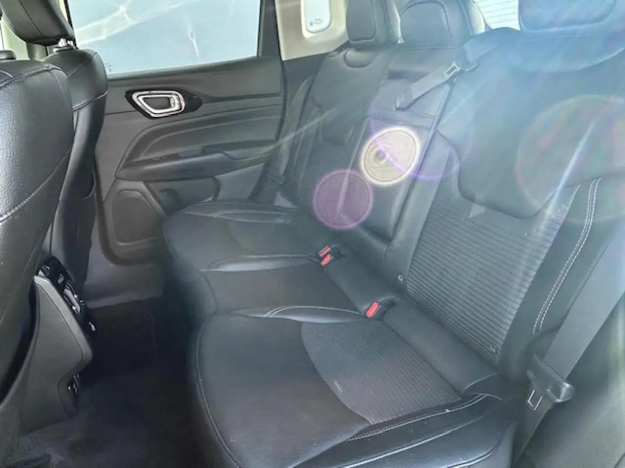Banquette arrière noire en cuir et tissu du Jeep Compass 2021, vue côté droit avec ceinture de sécurité visible.