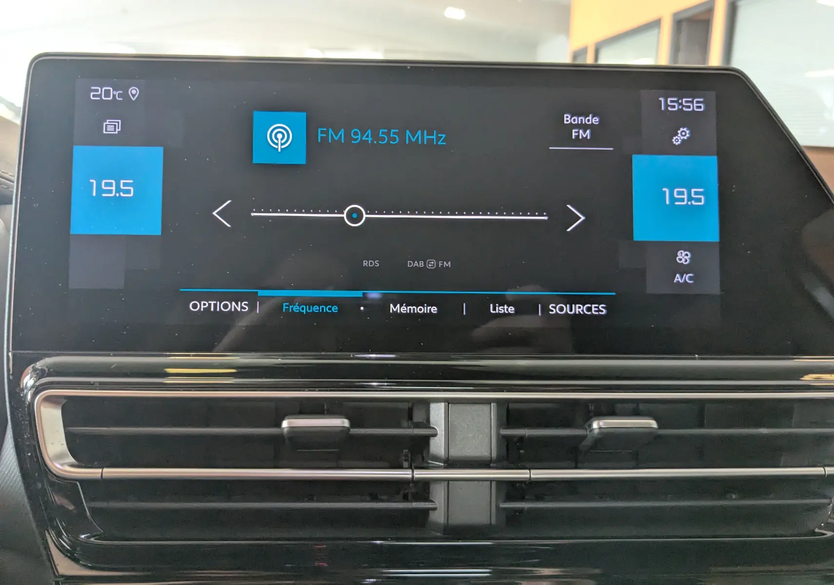 Écran tactile central du tableau de bord du Citroën C5 Aircross gris Artens, affichant la radio FM et la climatisation à 19,5°C.