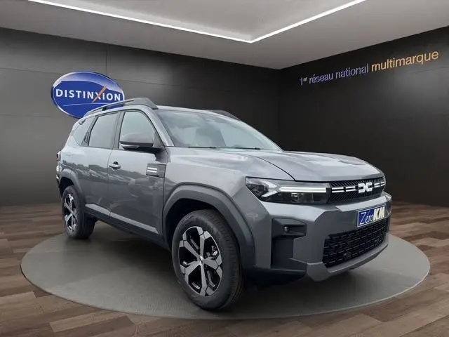 SUV Dacia Bigster gris foncé vu en 3/4 avant droit, avec calandre marquée et jantes alliage distinctives.