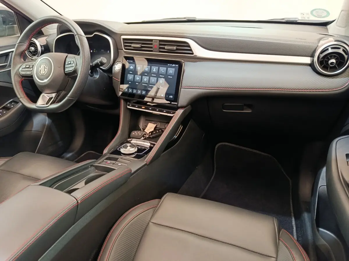 Intérieur noir du MG ZS Luxury 2024 vu côté conducteur, avec volant cuir et écran tactile central.