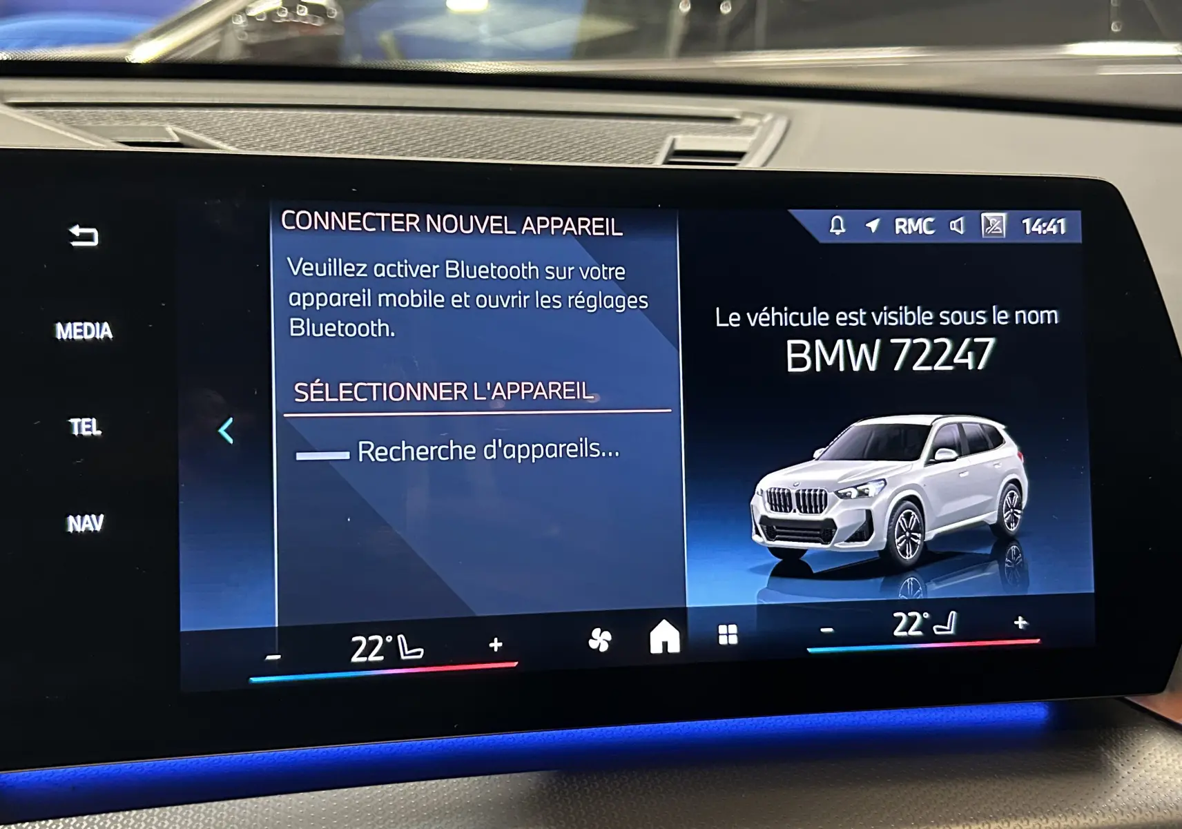 Écran tactile intérieur affichant une image 3/4 avant d'un BMW X1 Spacesilber sur fond bleu.