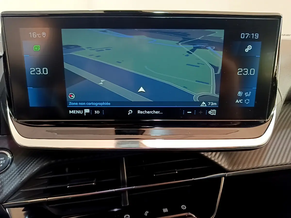 Écran tactile central du tableau de bord du Peugeot 2008 gris clair, affichant la navigation et la climatisation à 23°C.