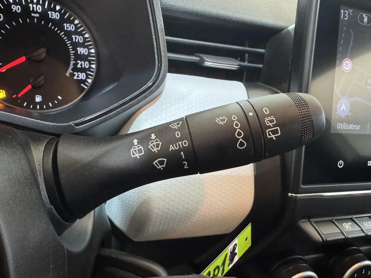 Gros plan sur la manette d’essuie-glace côté gauche du tableau de bord de la Renault Clio Business blanche 2023.