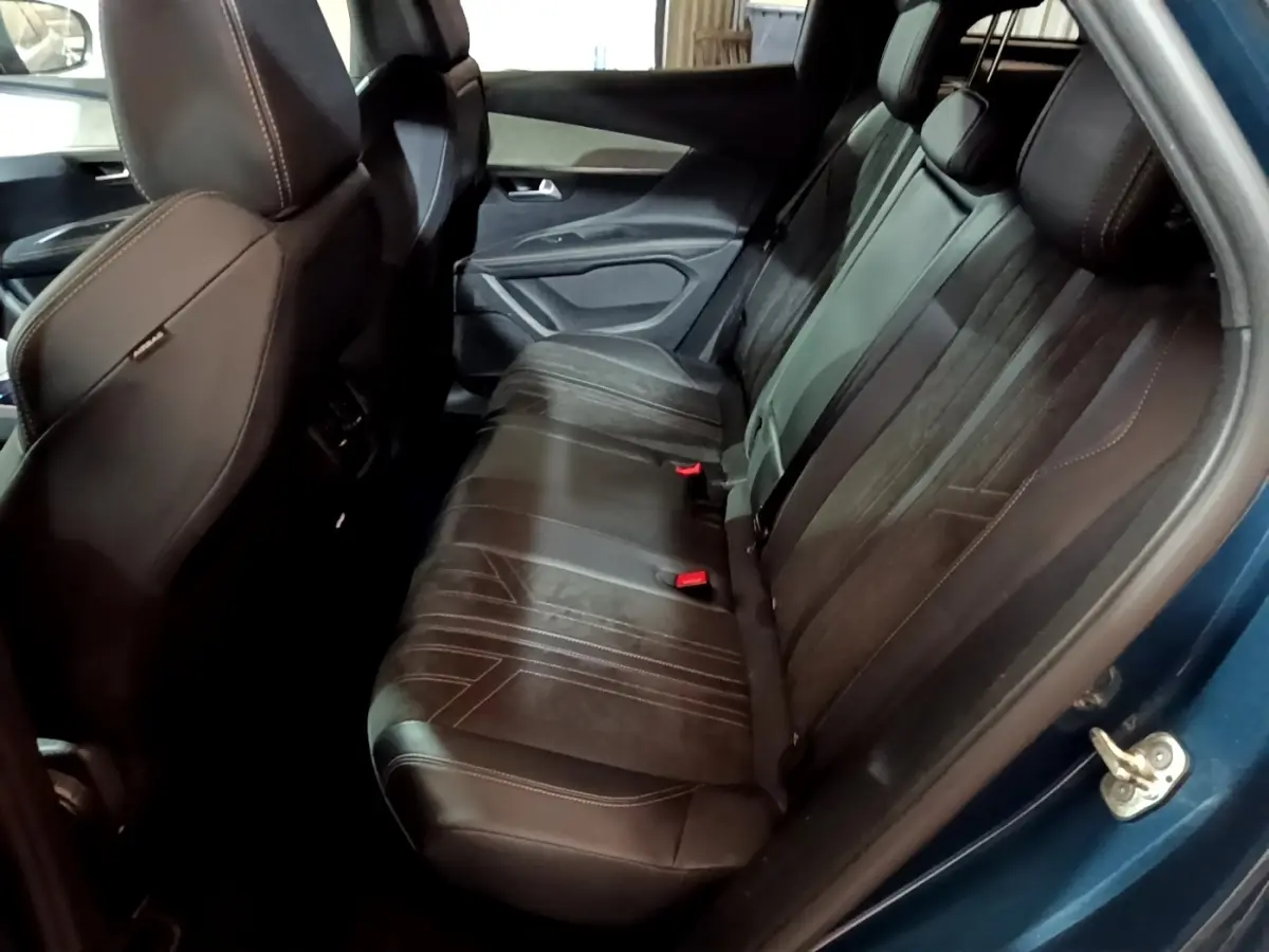 Vue intérieure côté droit des sièges arrière en cuir noir du Peugeot 3008 PureTech 130 GT bleu 2021.