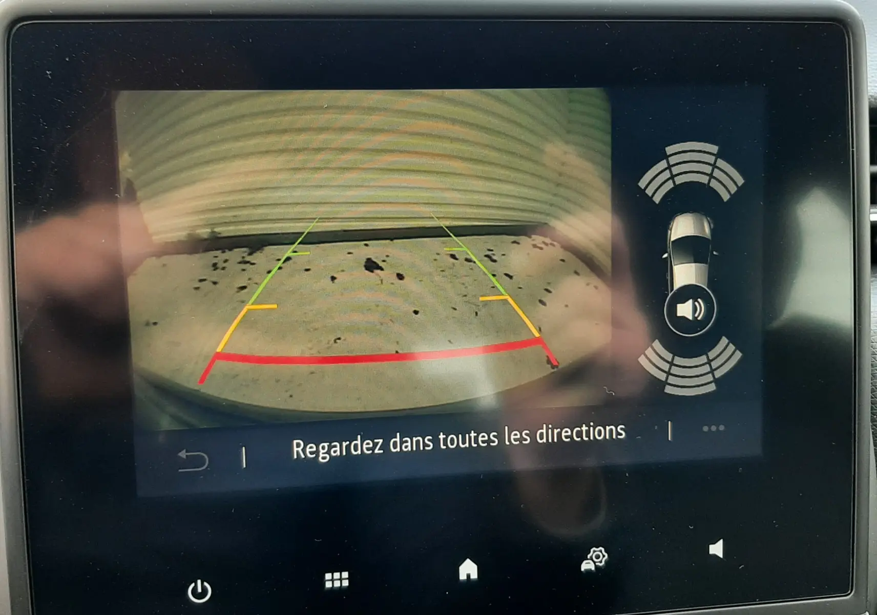 Écran multimédia montrant la caméra de recul avec lignes de guidage sur une Renault Clio V gris titanium de 2021.