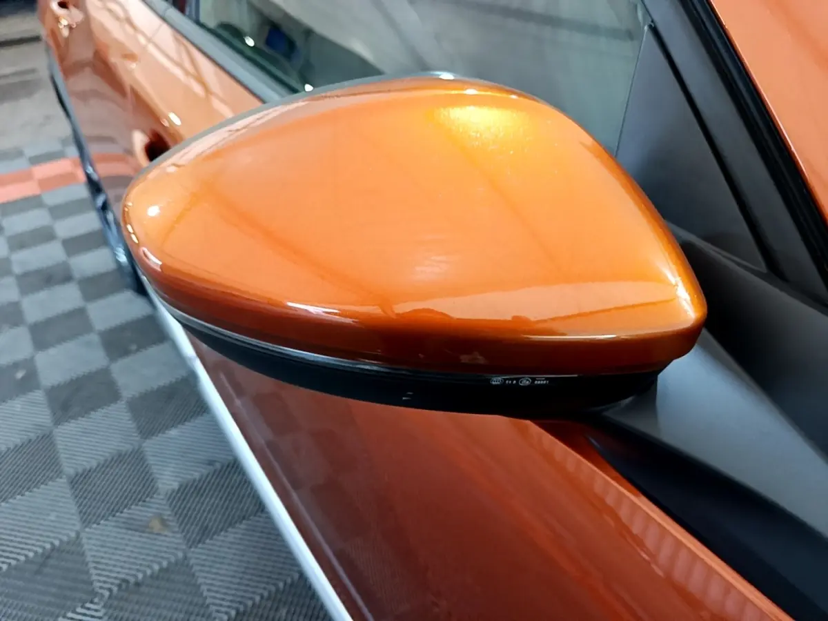 Rétroviseur côté gauche orange métallisé de la Peugeot 2008 PureTech 130, vue rapprochée sur la portière.