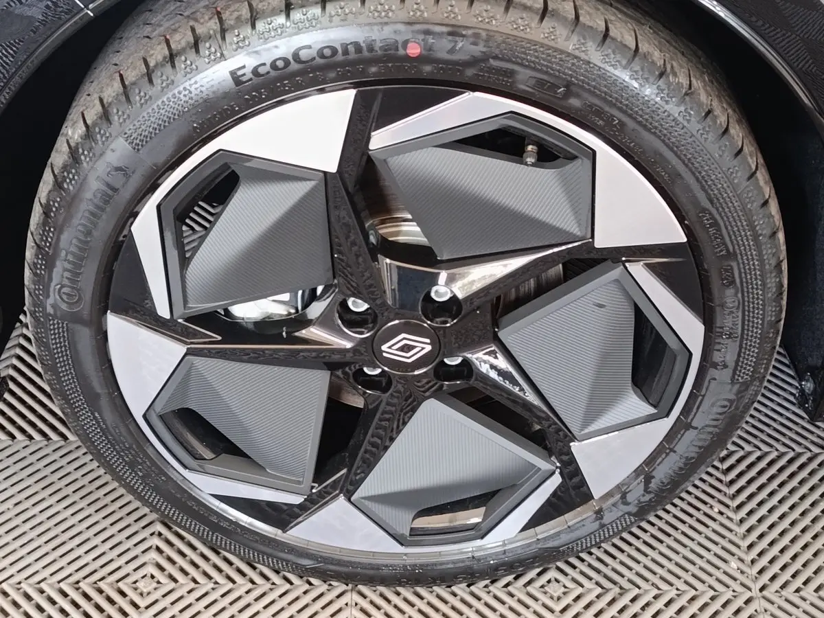 Gros plan sur la jante noire et grise au design géométrique de la Renault Clio Techno TCe 115 2026 gris foncé.