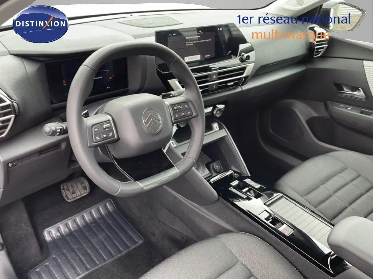 Vue intérieure côté conducteur de la Citroën C4 PureTech 130ch, tableau de bord moderne et volant multifonction noir.