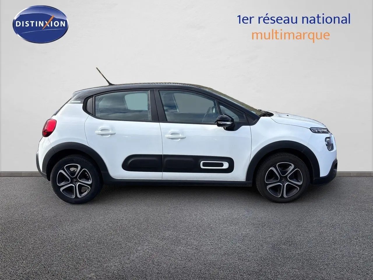 Profil droit d'une Citroën C3 blanc banquise 2022 avec protections latérales noires et jantes stylisées.