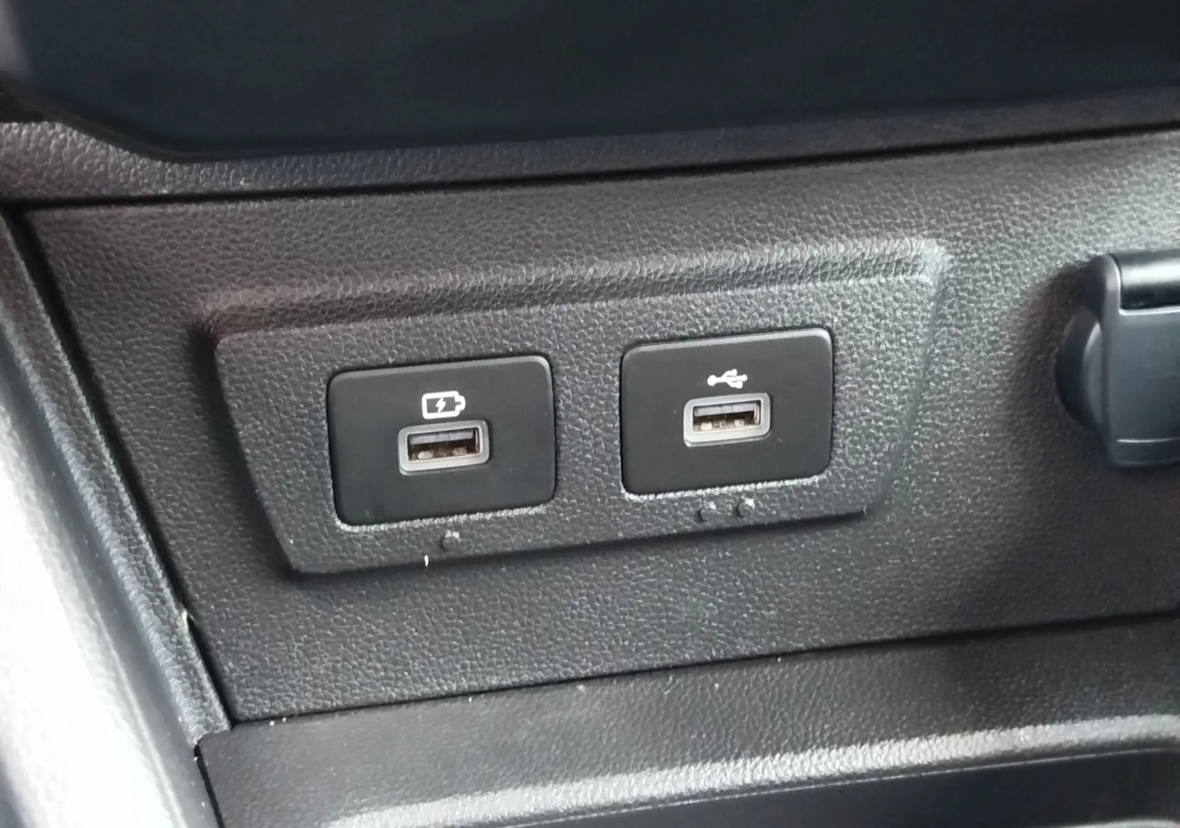 Gros plan sur les deux ports USB du tableau de bord d’un Dacia Duster 2024, finition Extreme, intérieur noir.