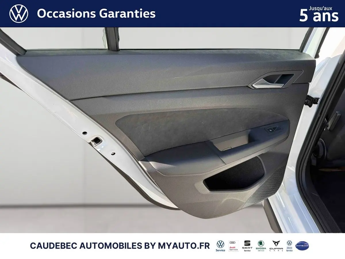 Vue rapprochée de la porte arrière droite blanche d'une Volkswagen Golf 1.5 eHybrid 2026, intérieur noir.