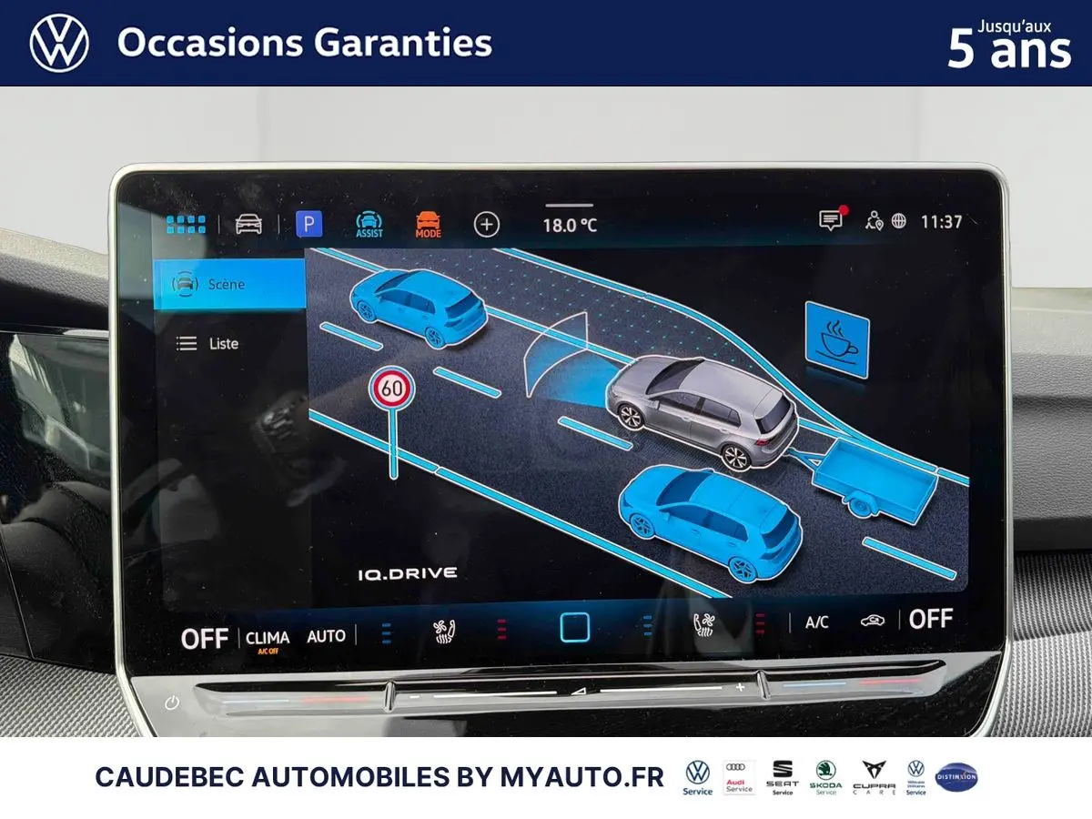 Écran tactile intérieur affichant l'assistance IQ.DRIVE avec représentation graphique de véhicules et panneaux routiers.