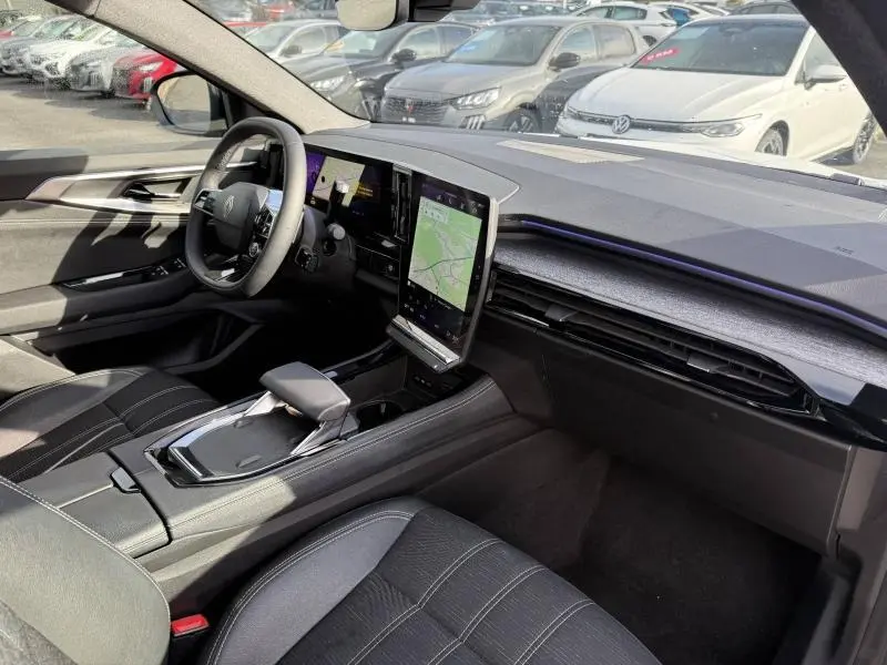 Vue intérieure côté conducteur du Renault Austral 2025 avec tableau de bord moderne et écran tactile vertical.