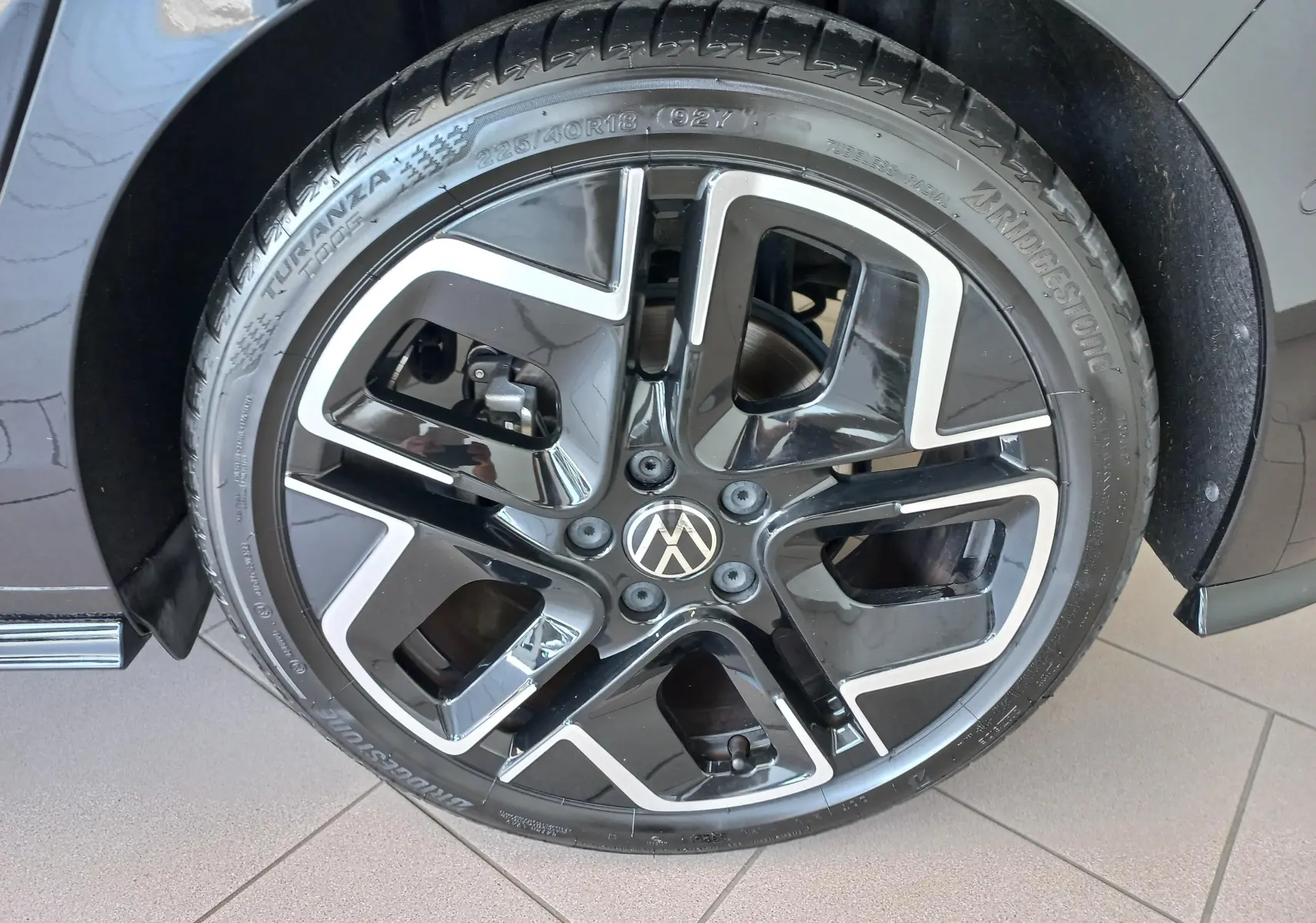 Gros plan sur la roue avant droite de la Volkswagen Golf 1.5 eTSI 150 DSG7 R-Line Edition noir ébène avec jante alliage noire et argent.