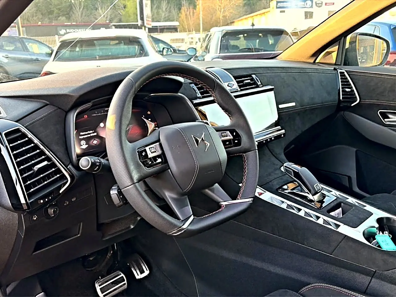 Intérieur de DS7 1.5 BlueHDi 130 noir, vue côté conducteur sur volant cuir et console centrale moderne.