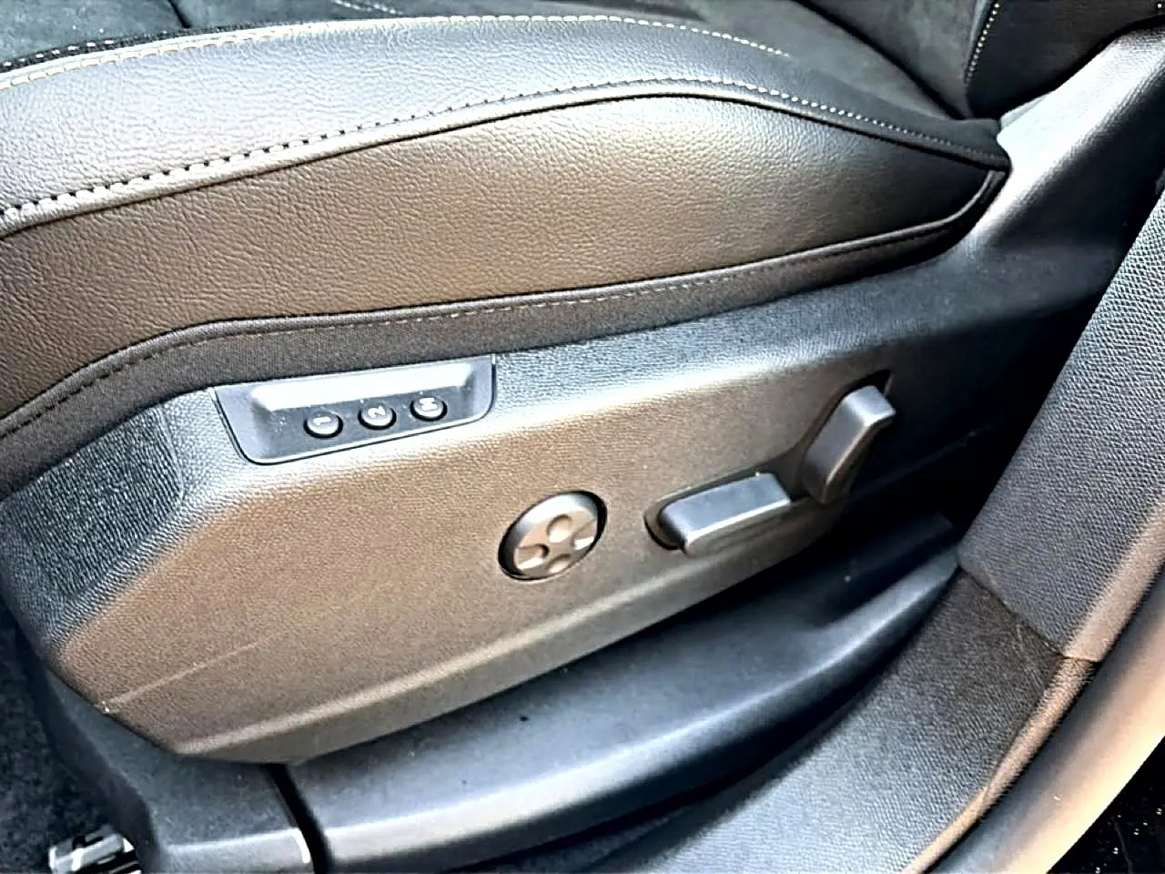 Gros plan sur les commandes électriques du siège conducteur en cuir noir du DS7 1.5 BlueHDi 130 Performance Line 2026.
