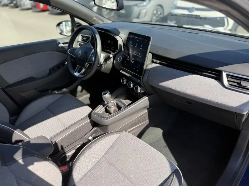 Vue intérieure côté conducteur de la Renault Clio 1.0 TCe 90ch Techno 2025 avec écran tactile vertical et volant multifonction.