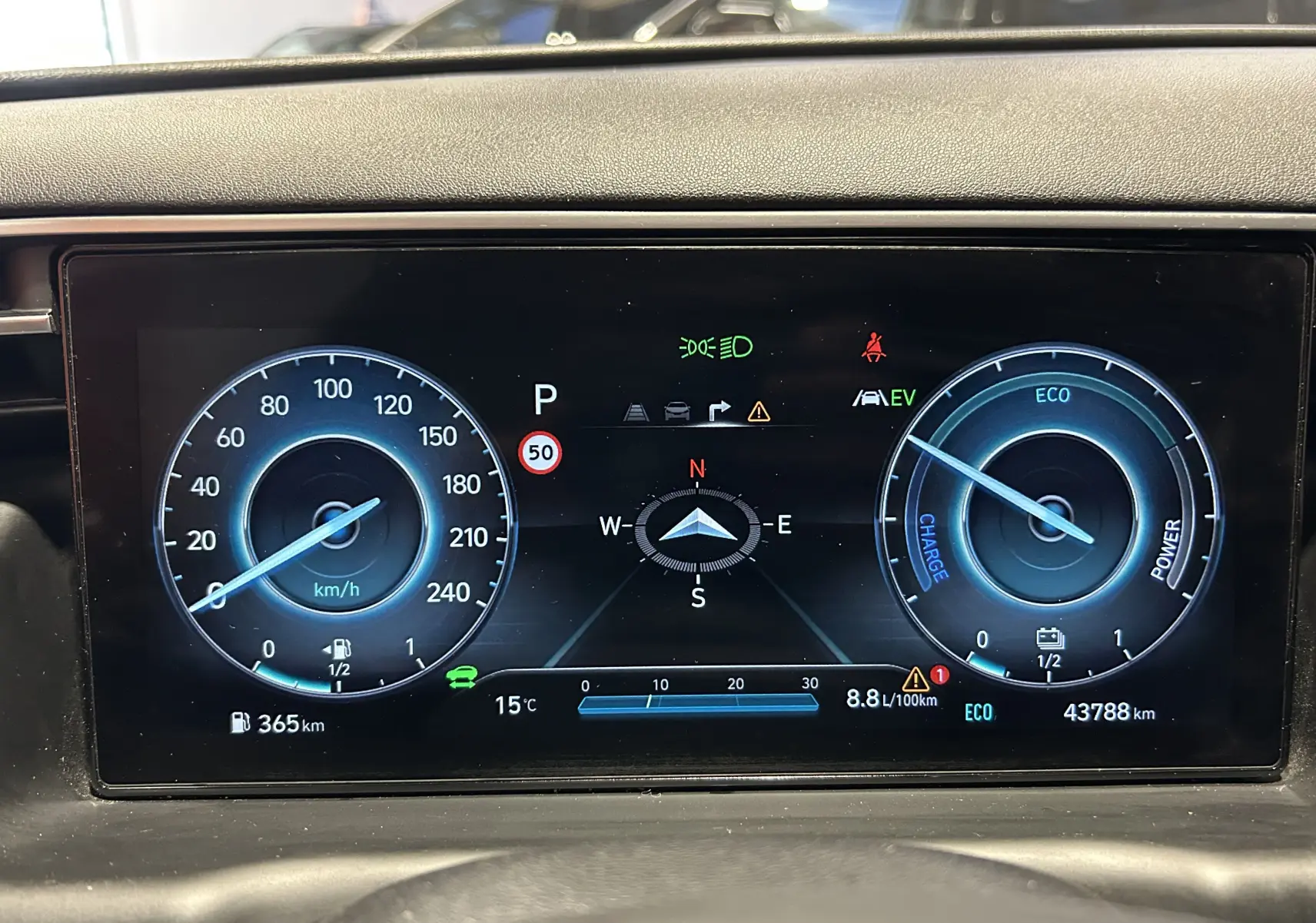 Tableau de bord numérique du Hyundai Tucson Hybrid 2022 affichant vitesse, autonomie, température et mode ECO.