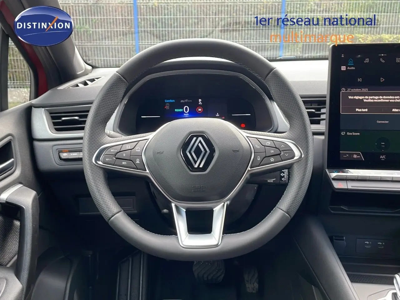 Vue centrée sur le volant du Renault Captur E-Tech hybride 2025, avec tableau de bord numérique et écran tactile.