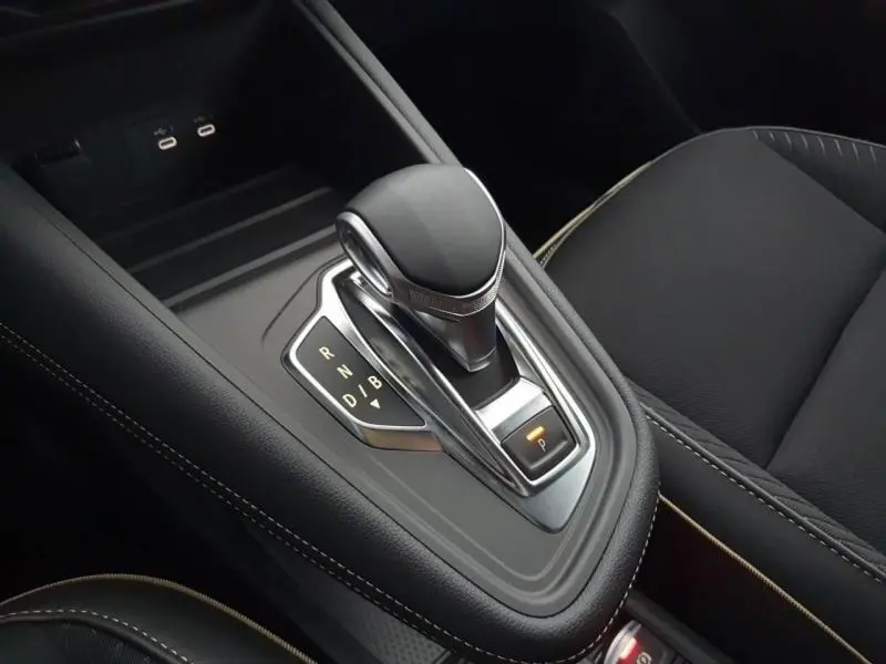 Vue rapprochée de la console centrale noire étoilé du Renault Symbioz 2025 avec levier de boîte automatique et siège côté droit.