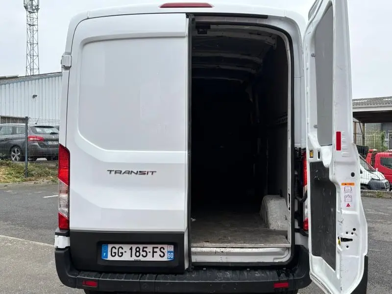 Vue arrière d'un Ford Transit Fourgon blanc Glacier 2022 avec porte battante droite ouverte dévoilant l'espace de chargement.