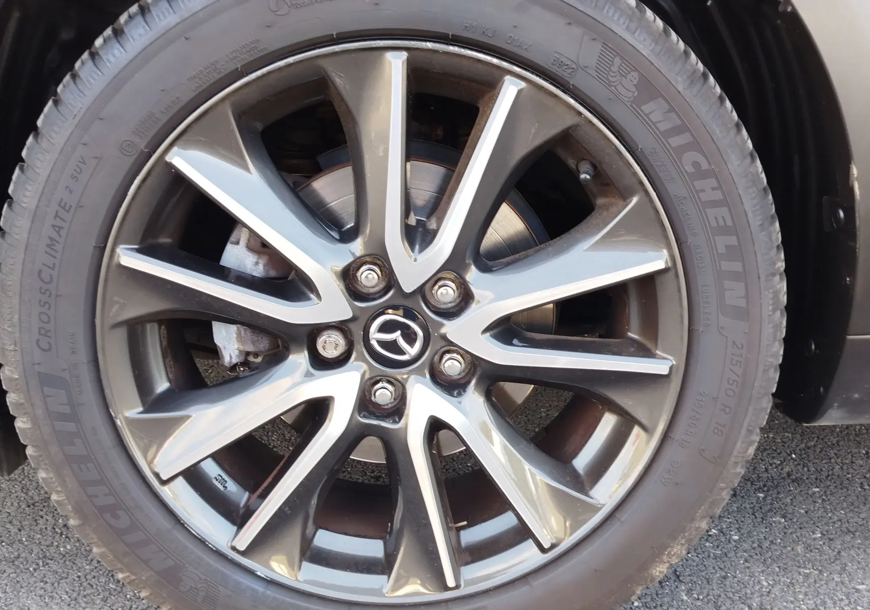 Gros plan sur la jante alliage grise et noire du Mazda CX-3 2016 avec pneu Michelin CrossClimate.