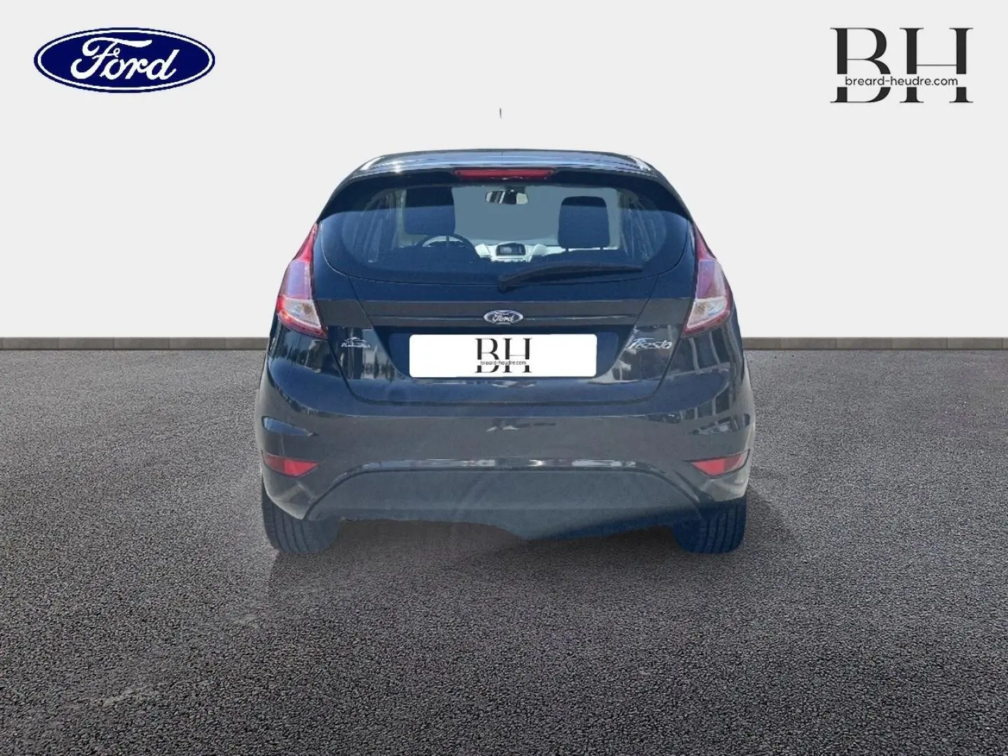 Vue arrière d'une Ford Fiesta noire Scala 2015, avec feux arrière et becquet visibles sur fond neutre.