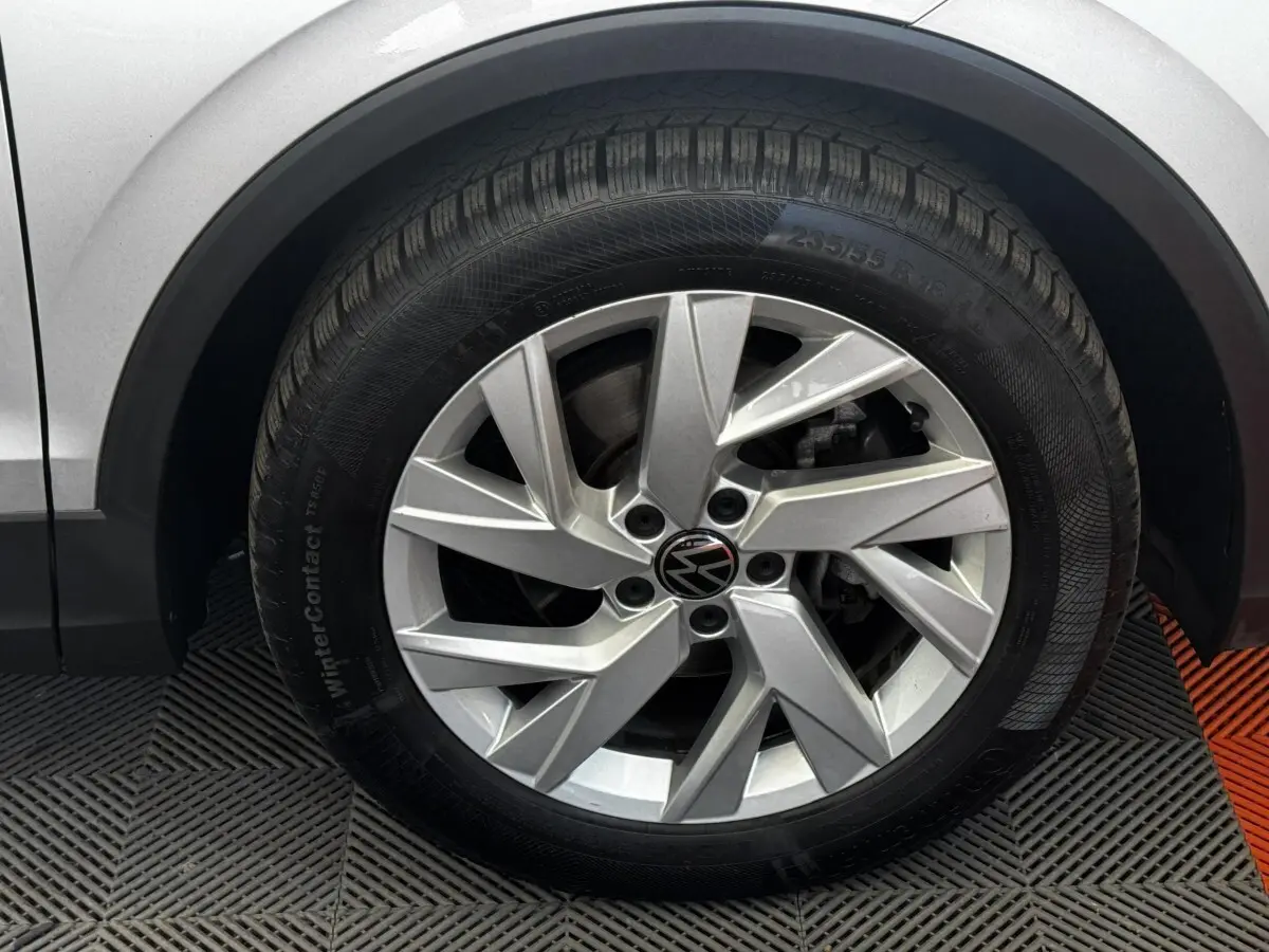 Gros plan sur la roue avant gauche gris clair du Volkswagen Tiguan 1.5 TSI 150 DSG7 Elegance avec jante alliage à cinq branches doubles.