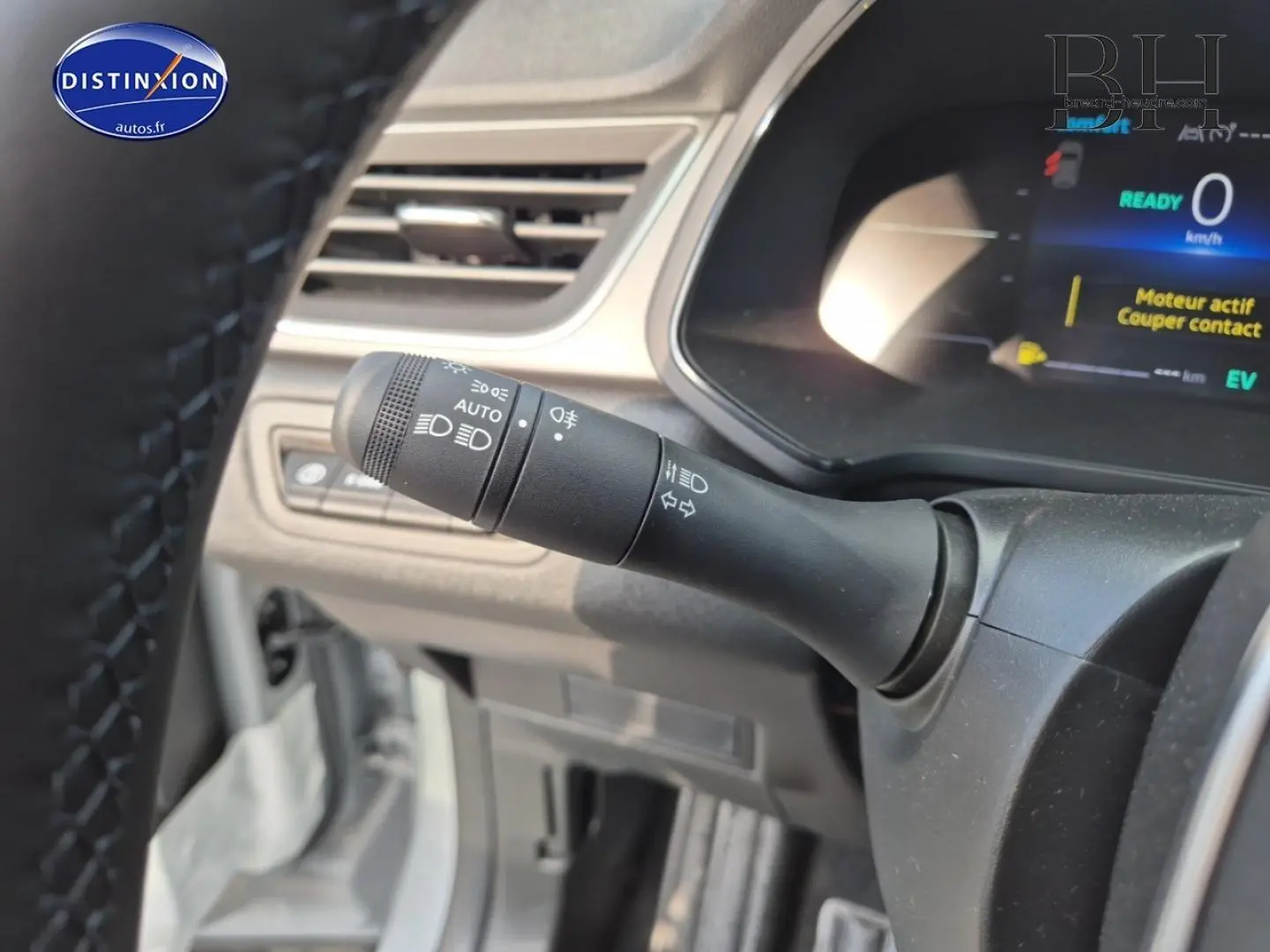 Gros plan sur la commande des phares et clignotants côté gauche du tableau de bord du Renault Captur bleu Iron 2025.