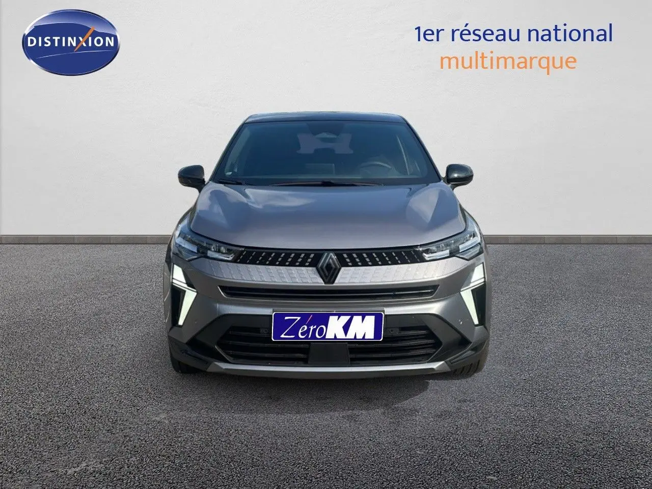 Vue frontale du Renault Captur E-Tech hybride gris Cassiopée avec toit noir, mettant en valeur sa calandre moderne et ses feux LED.