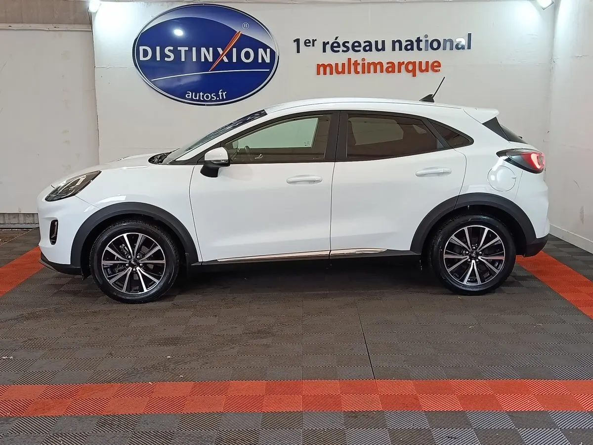 Ford Puma blanc vue de profil côté gauche, avec jantes alliage noires et toit légèrement incliné.