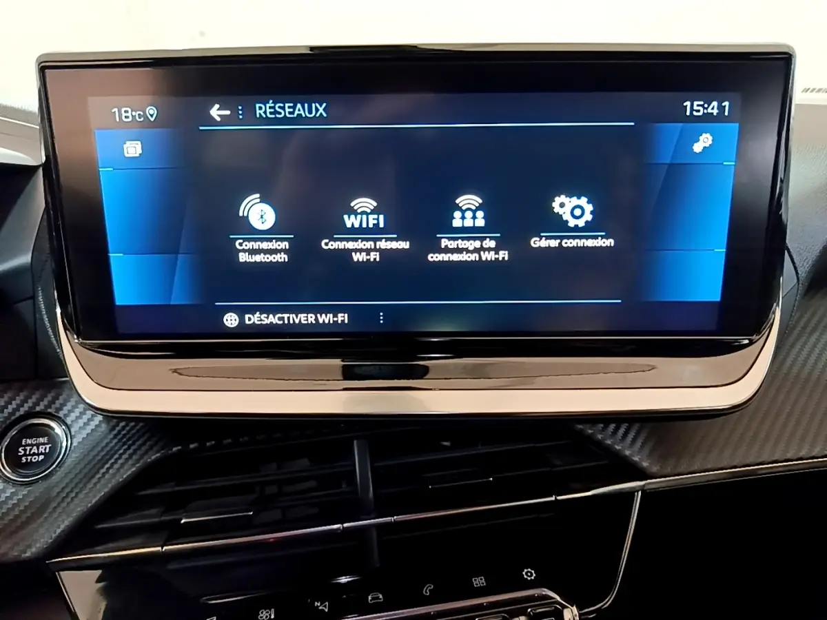 Écran tactile central du tableau de bord du Peugeot 2008 gris clair, affichant les options de connexion Wi-Fi et Bluetooth.